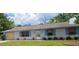 Charming single-story home featuring light blue siding and well-maintained landscaping at 235 Rockmoore Ct, Deland, FL 32720