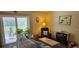 Cozy living room with comfortable seating, warm lighting, and a view to the outside patio at 235 Rockmoore Ct, Deland, FL 32720