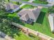 Aerial view of the home featuring a screened porch and well-manicured backyard at 2369 Five Forks Trl, The Villages, FL 32162