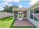 Well-maintained backyard featuring a screened porch and lush lawn at 2369 Five Forks Trl, The Villages, FL 32162