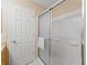 Bathroom shower with a glass sliding door and a built in seat for comfort and accessibility at 2369 Five Forks Trl, The Villages, FL 32162