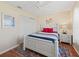 Cozy bedroom featuring a white four-poster bed with colorful bedding and a decorative area rug at 2369 Five Forks Trl, The Villages, FL 32162