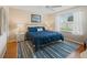 Comfortable bedroom featuring a blue quilted bedspread and white wicker nightstands at 2369 Five Forks Trl, The Villages, FL 32162