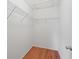 Walk-in closet with vinyl wood flooring and adjustable wire shelving at 2369 Five Forks Trl, The Villages, FL 32162