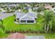 Overhead view of a home with a screened-in lanai, lush landscaping, and meticulous lawn maintenance at 2455 Five Forks Trl, The Villages, FL 32162
