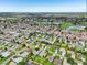 Scenic aerial view of a planned community with mature trees, golf course, and several ponds at 2455 Five Forks Trl, The Villages, FL 32162