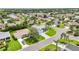 A peaceful neighborhood showcasing a well-maintained home with lush landscaping and a verdant lawn at 2455 Five Forks Trl, The Villages, FL 32162