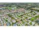 Expansive areal photo of a community near a golf course and a network of ponds at 2455 Five Forks Trl, The Villages, FL 32162