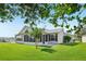 Nice backyard featuring lush green grass and a covered lanai attached to the home at 2455 Five Forks Trl, The Villages, FL 32162