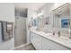 Bright bathroom with double vanity, marble countertops, and walk-in shower at 2455 Five Forks Trl, The Villages, FL 32162