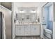 Elegant bathroom with double vanity, granite countertops, modern lighting, and a walk-in shower at 2455 Five Forks Trl, The Villages, FL 32162