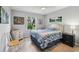 Cozy bedroom featuring a bed, dresser, and a large window for natural light at 2455 Five Forks Trl, The Villages, FL 32162