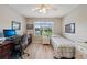 Bedroom featuring a well-lit desk area and large window overlooking the outdoors at 2455 Five Forks Trl, The Villages, FL 32162