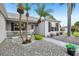 Charming front porch adorned with tropical plants and a tranquil, gravel yard at 2455 Five Forks Trl, The Villages, FL 32162