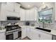Well-equipped kitchen with stainless steel appliances, granite countertops, and tiled backsplash at 2455 Five Forks Trl, The Villages, FL 32162