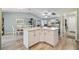 Spacious kitchen island with white cabinets and granite countertops, ideal for entertaining at 2455 Five Forks Trl, The Villages, FL 32162
