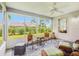 The screened lanai provides a relaxing space with comfortable seating and a ceiling fan at 2455 Five Forks Trl, The Villages, FL 32162