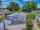 An aerial view of a light blue house featuring mature trees, a landscaped yard, and a long driveway at 25007 Bellevue, Leesburg, FL 34748