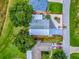 Aerial view of home with clearly outlined lot, situated in a well-treed neighborhood close to other homes at 25007 Bellevue, Leesburg, FL 34748