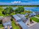 Aerial view of a home with lake view, landscaped yard, and community setting, offering a glimpse of serene living at 25007 Bellevue, Leesburg, FL 34748