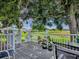 Relaxing backyard deck overlooking a beautiful green lawn, lake and mature trees at 25007 Bellevue, Leesburg, FL 34748