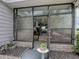 Charming entrance with decorative glass doors and a view into a sunroom with comfortable seating at 25007 Bellevue, Leesburg, FL 34748