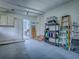 Clean garage with white cabinets, shelves, and access to another room with storage at 25007 Bellevue, Leesburg, FL 34748