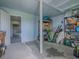 Garage with utility storage, open to another larger garage space beyond at 25007 Bellevue, Leesburg, FL 34748
