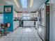 Bright kitchen featuring white cabinets, stainless steel appliances, tile floor, and natural light from skylights at 25007 Bellevue, Leesburg, FL 34748