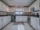 Well-lit kitchen showcases white cabinets, granite countertops, stainless steel range, and tile backsplash at 25007 Bellevue, Leesburg, FL 34748