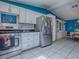 Open-concept kitchen with modern appliances, white cabinets, stainless steel range, and adjacent dining area at 25007 Bellevue, Leesburg, FL 34748