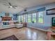 Cozy living room with large windows, natural light, and hardwood floors at 25007 Bellevue, Leesburg, FL 34748