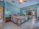 This is a bright main bedroom with a ceiling fan, walk-in closet, and a comfortable bed at 25007 Bellevue, Leesburg, FL 34748