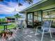 Cozy porch with chairs, table, and peaceful outdoor seating area, creating a perfect spot for relaxation at 25007 Bellevue, Leesburg, FL 34748