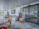 Relaxing sunroom with comfortable seating, ceiling fans, and sliding glass doors leading to the outside at 25007 Bellevue, Leesburg, FL 34748