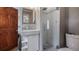 Modern bathroom with tiled shower and pebble floor, along with a sleek vanity sink at 256 Carroll St, Clermont, FL 34711