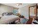 Bedroom with hard floors, ceiling fan, neutral walls and view to adjacent bedroom at 256 Carroll St, Clermont, FL 34711