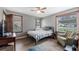 Comfortable bedroom with wood-look floors, ceiling fan, and large windows at 256 Carroll St, Clermont, FL 34711