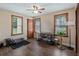 Bedroom featuring a ceiling fan, hardwood floors, and three windows providing plenty of natural light at 256 Carroll St, Clermont, FL 34711