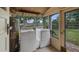 Laundry room with washer, dryer, and water heater; bright natural light through windows at 256 Carroll St, Clermont, FL 34711