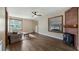 Cozy living room with hardwood floors, a ceiling fan and a decorative fireplace at 256 Carroll St, Clermont, FL 34711