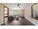 Inviting living room featuring wood-look floors, a ceiling fan, and natural light at 256 Carroll St, Clermont, FL 34711