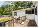 Backyard of white house with a small deck, and green grass at 25824 Shawnee St, Sorrento, FL 32776