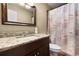 Bathroom featuring granite vanity and a shower with decorative curtain at 25824 Shawnee St, Sorrento, FL 32776