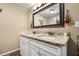 Bathroom featuring a double sink vanity with granite countertop and large mirror at 25824 Shawnee St, Sorrento, FL 32776