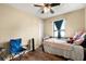 Simple bedroom with wood flooring, a twin bed and a window with natural light, offering a cozy space at 25824 Shawnee St, Sorrento, FL 32776