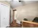 Bedroom featuring laminate wood flooring, closet, and doorway to another room at 25824 Shawnee St, Sorrento, FL 32776