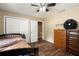 Spacious bedroom featuring laminate wood flooring, closet and standard ceiling fan at 25824 Shawnee St, Sorrento, FL 32776