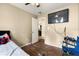 Cozy bedroom with wood flooring, a ceiling fan, and convenient access to an adjacent room at 25824 Shawnee St, Sorrento, FL 32776