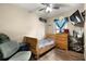 Cozy bedroom featuring a wood sleigh bed, ceiling fan, and laminate wood flooring at 25824 Shawnee St, Sorrento, FL 32776